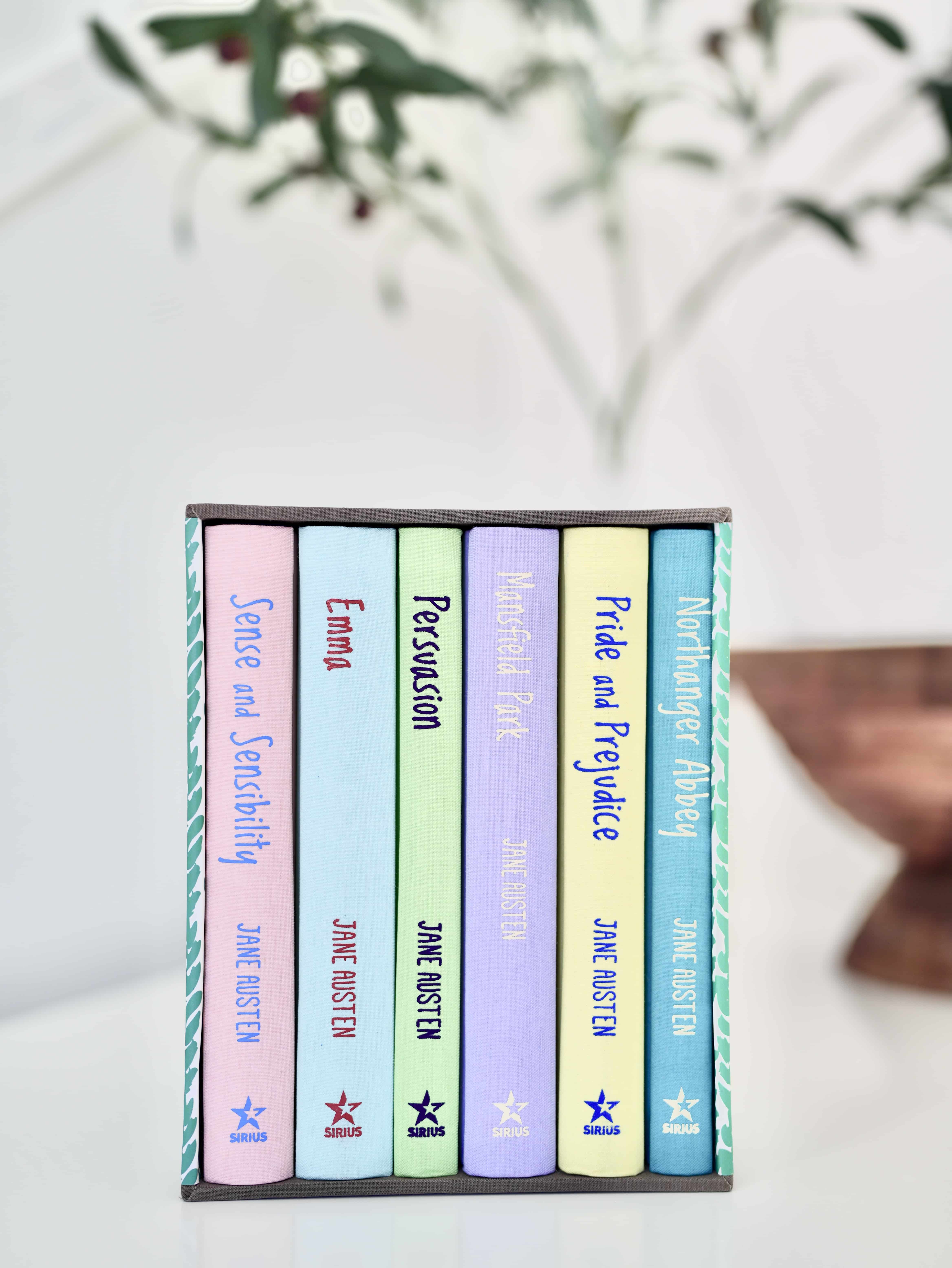 Boxed set of six Jane Austen novels. Hardcover books feature pastel colors of pink, light blue, green, lavender, yellow, and seafoam.