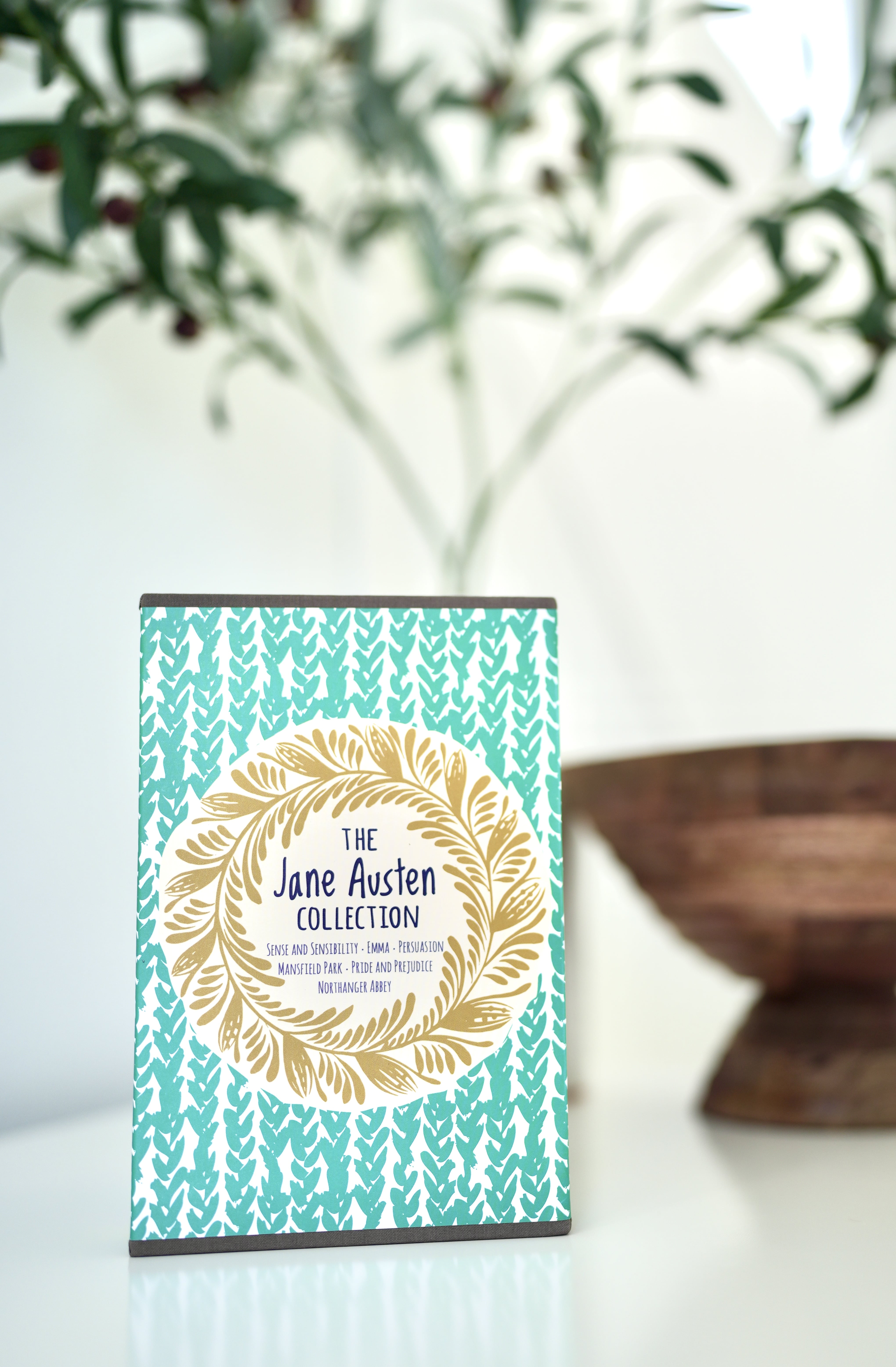 Front photo of a boxed book set collection of Jane Austen Novels. Text on cover reads "The Jane Austen Collection". Set on white background next to brown decorative bowl.