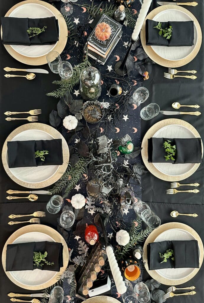 Halloween tablescape with gold charger plates, black