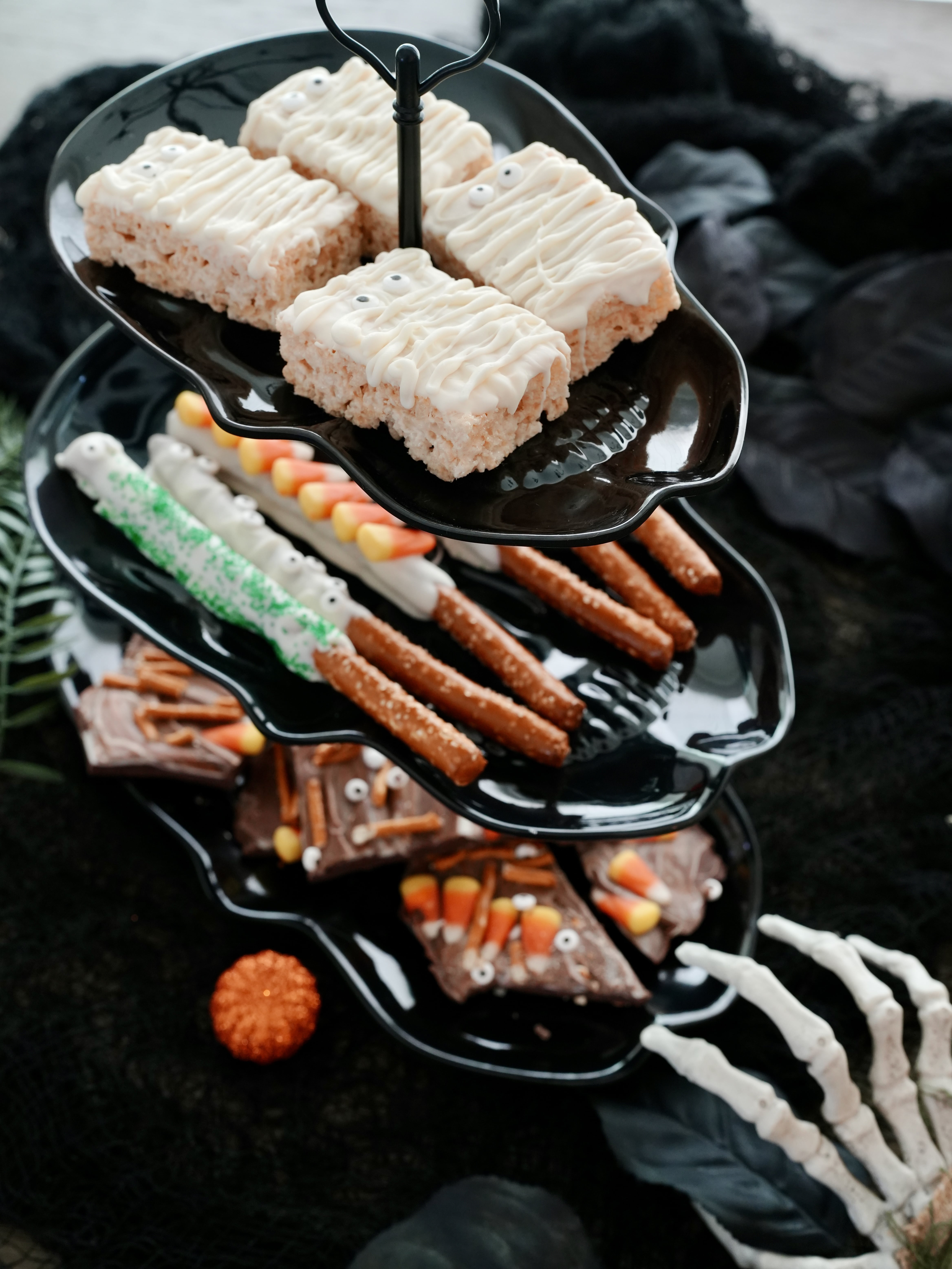 3 tier Halloween board with rice krispies mummies, spooky pretzel rods, and Halloween bark
