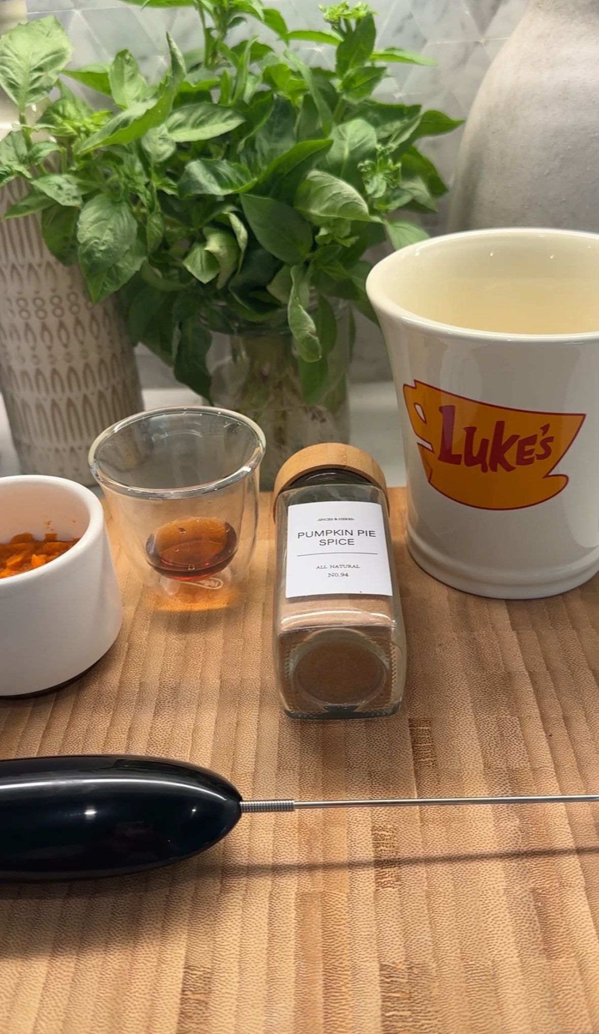 Ingredients on cutting board for Pumpkin Spice Latte, along with Luke's coffee mug